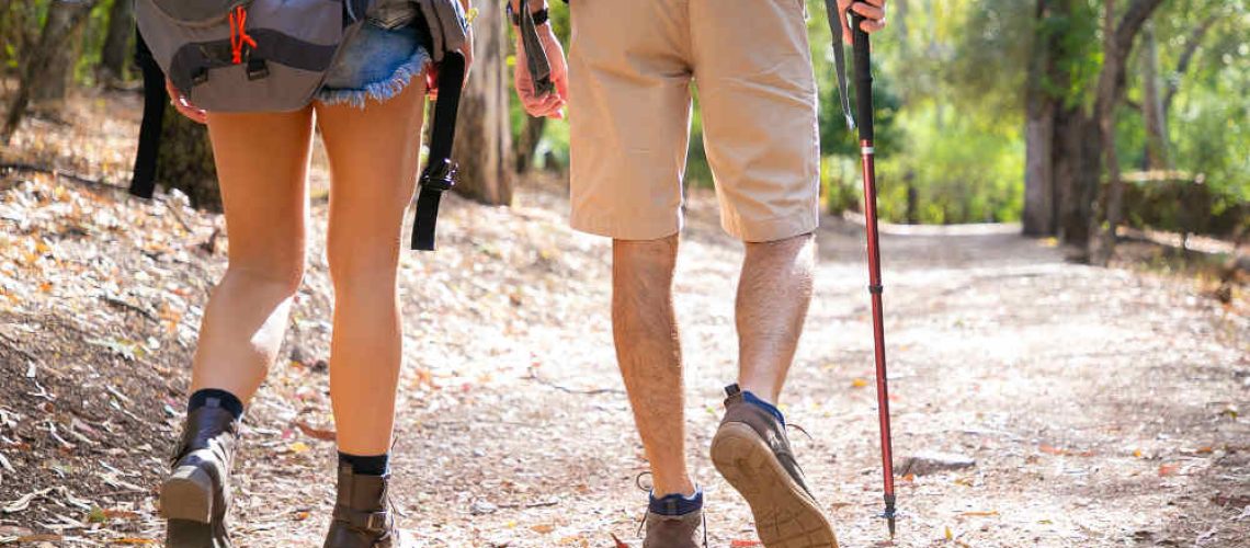 back-view-couple-hiking-together-road-unrecognizable-man-woman-walking-nature-legs-tourists-trekking-with-backpacks-sunny-day-tourism-adventure-summer-vacation-concept (1)
